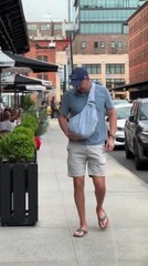 Man Carries Puppy in Bag