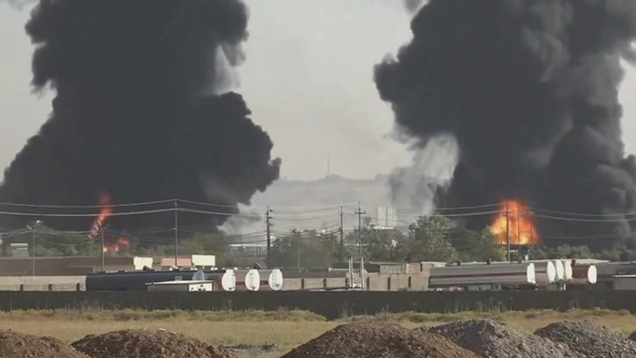 Plumes of black smoke fill sky during huge oil refinery fire in Iraq