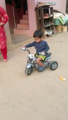 My son raiding his moterbike.
