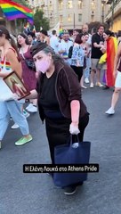 Christian woman holds JESUS portrait in front of LGBTQI+ activists at Athens Pride event.