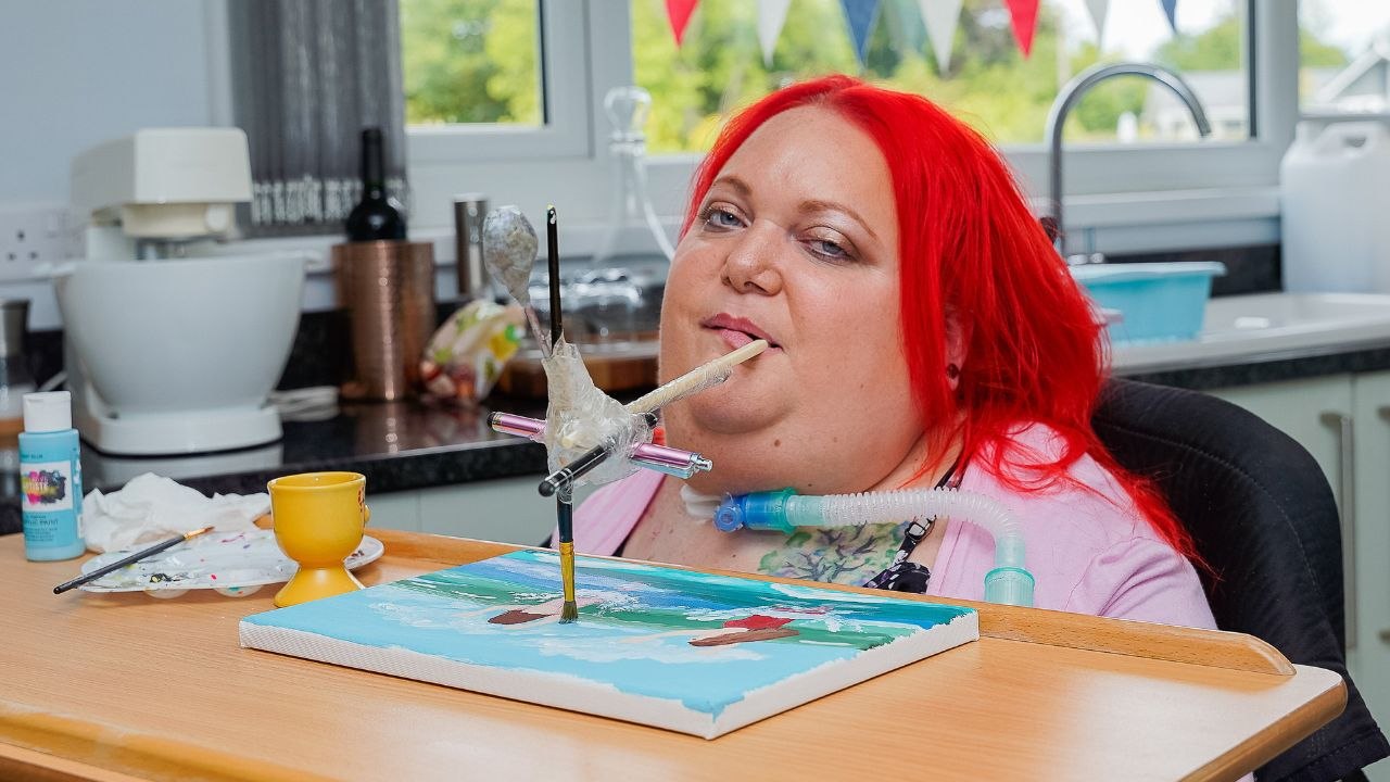 Woman paralysed when she fell learning to walk as baby paints art with mouth
