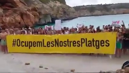 Majorca anti-mass tourism protesters ‘occupy’ beach