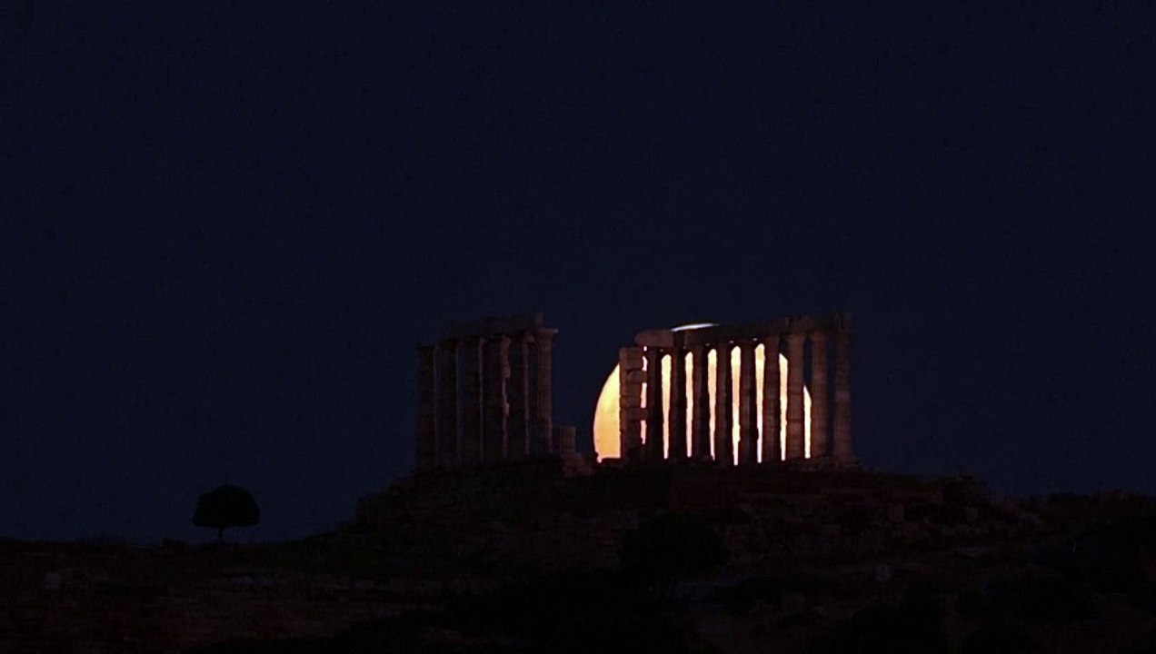 'Strawberry Moon' rises behind ancient Greek temple