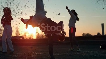 Young Man Showing Breakdance Moves While Dancing With Friends