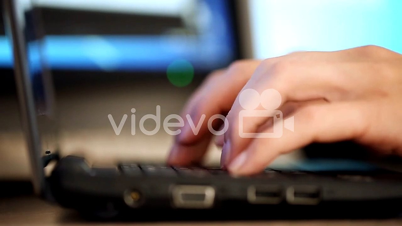 Fingers typing on keyboard