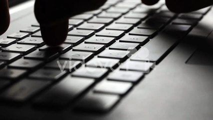 closeup of fingers typing on laptop computer keyboard
