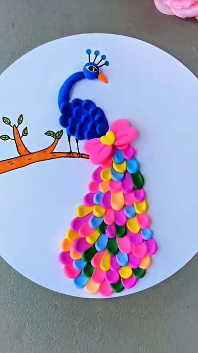 Crafted a vibrant canvas from simple materials,   this clay crafted peacock transforming any space into a...on.   .. Follow me for more-  @itsy_bitsy_23  @itsy_bitsy_23  @itsy_bitsy_23..#CraftedBeauty #DIYArt #UpcycledCreations