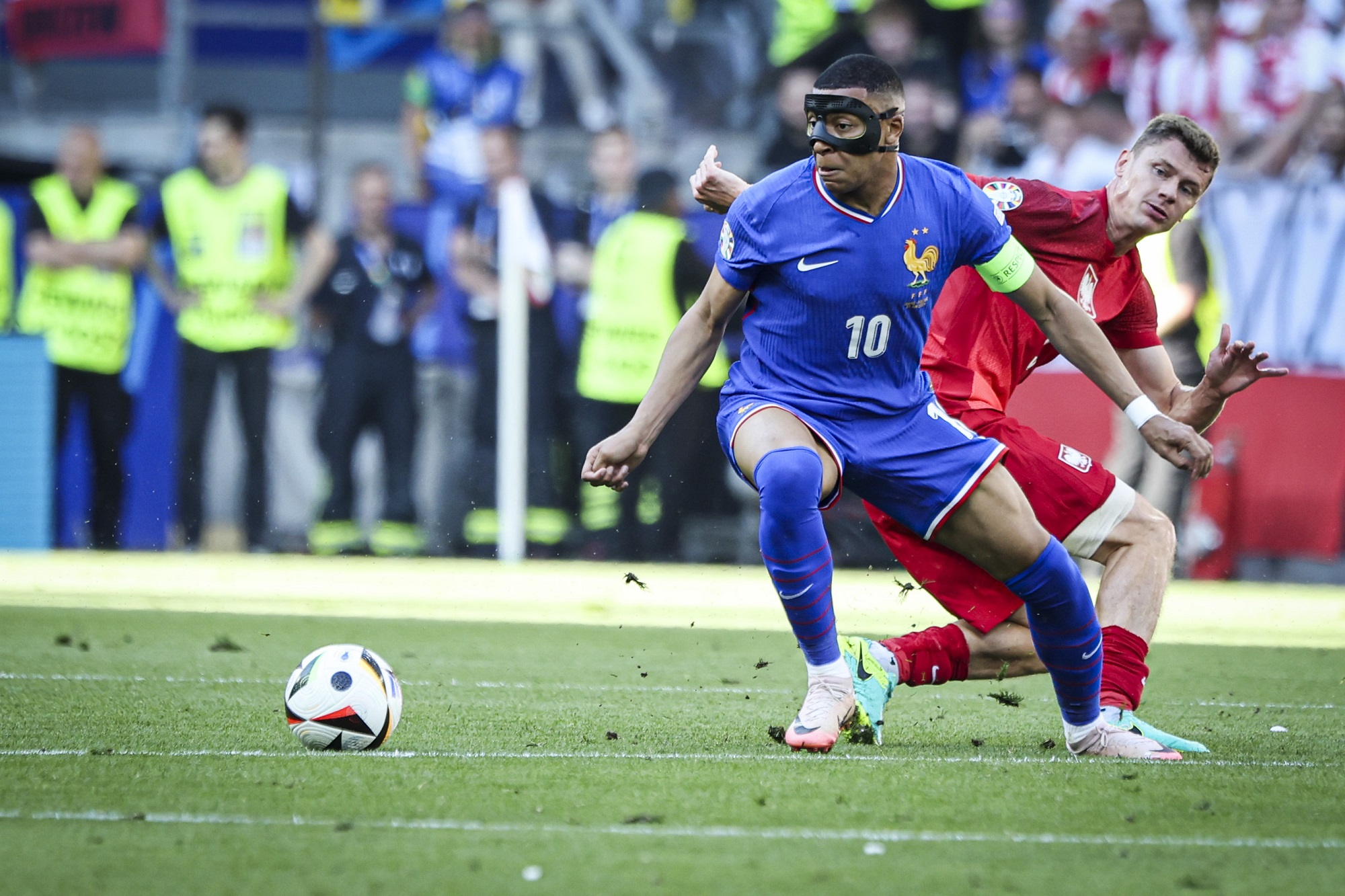 Masked Mbappe trains with France