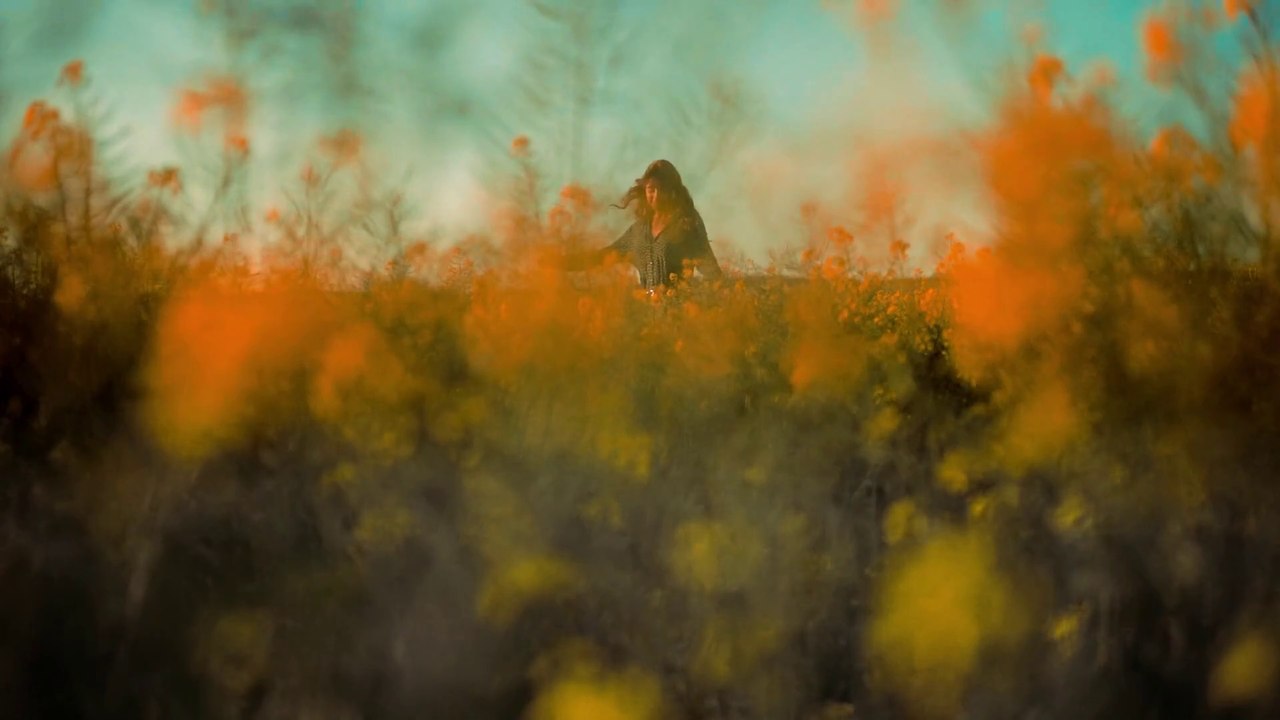 A Woman Dancing Happily In The Middle Of The Field Of Flowers