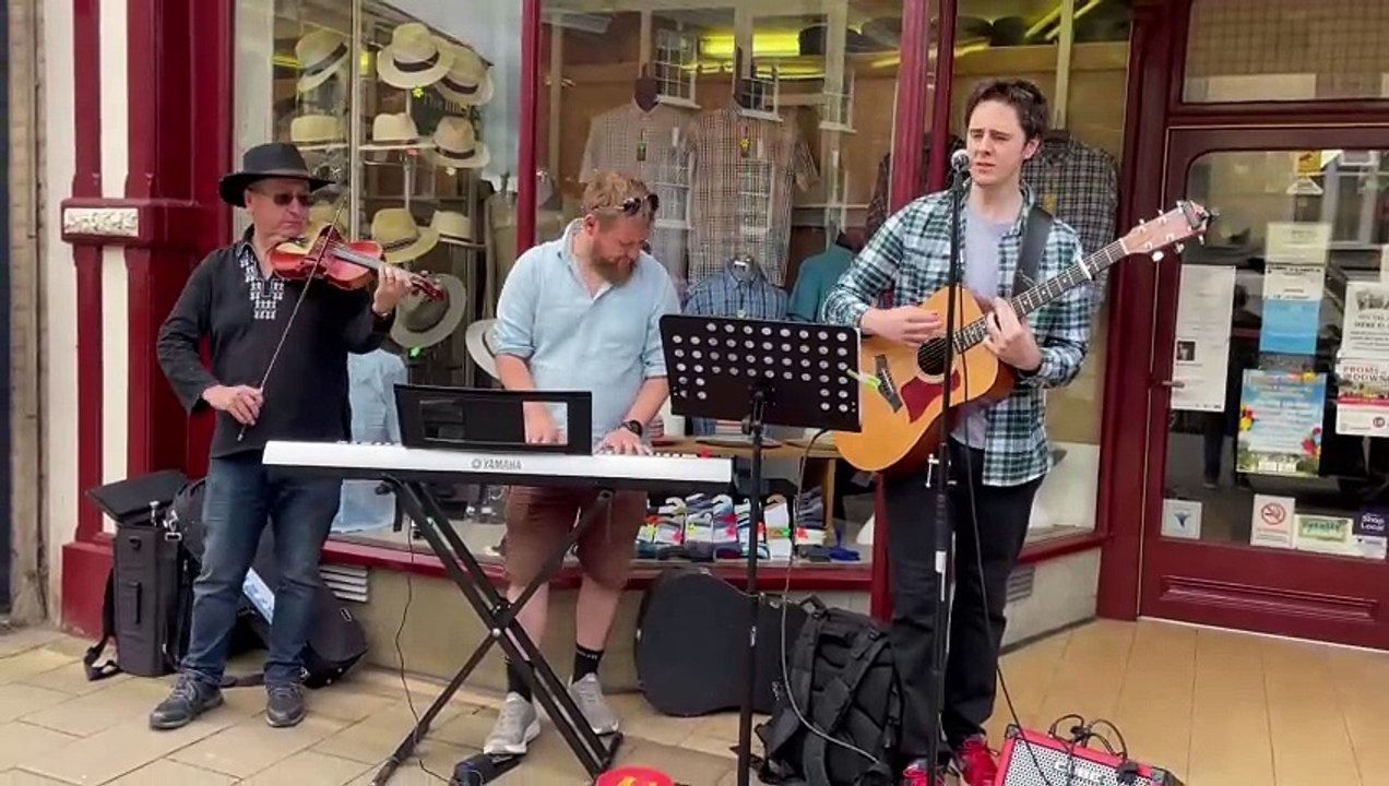 Buskers outside A E Lee (Outfitters) Ltd as part of Busk It! AQ 5578