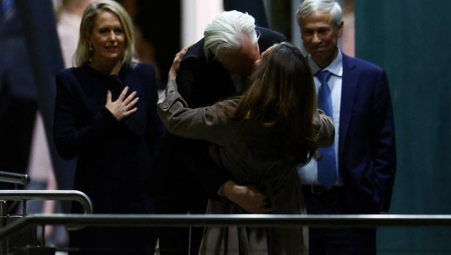 Julian Assange hugs and kisses wife as he arrives in Australia to cheering crowds