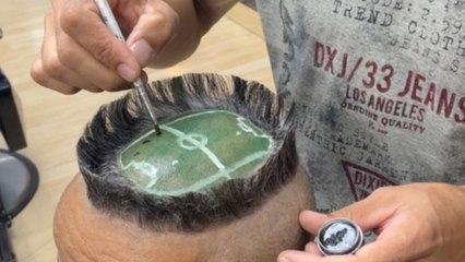 Hairdo wizard transforms client's head into a miniature football stadium