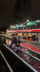 Woman Trying to Cross Water by Walking on Beams Accidentally Falls