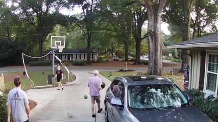 Man Makes Trick Shot with Basketball While Playing with Family
