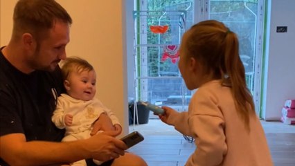 Sister's doctor play makes a little girl burst with laughter