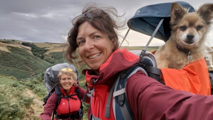 Couple and pampered pooch enjoying England's longest dog walk