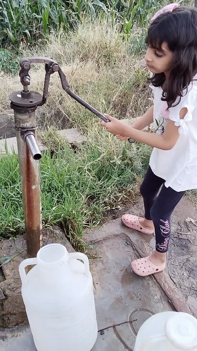 Fatima bringing water for home