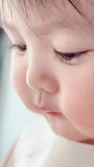 A cute baby is eating a watermelon 