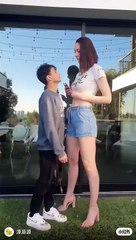 Small boy kiss the large girl very funny