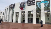 Palestine protesters unfurl banners on the front of Parliament House
