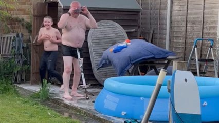 Man's poolside pogo stick jump ends in a big splash