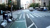 A foolish driver trying to turn left from the center lane in New York City gets honked at by trucks and cyclists