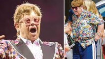 Singer Elton John Pees Into A Plastic Bottle, In A Shopping Store