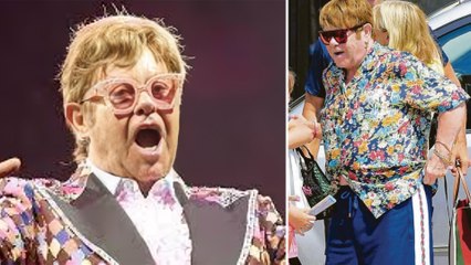 Singer Elton John Pees Into A Plastic Bottle, In A Shopping Store