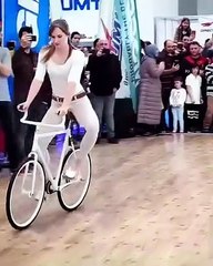 Woman showing tricks on bicycle