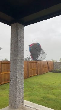 Trampoline Flies Over Fence During Wind Storm in Houston, Texas