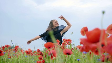 mixkit-girl-dancing-happily-in-a-field-of-flowers-4702-4k