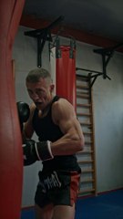 Male Boxer Practicing on Punching Bag
