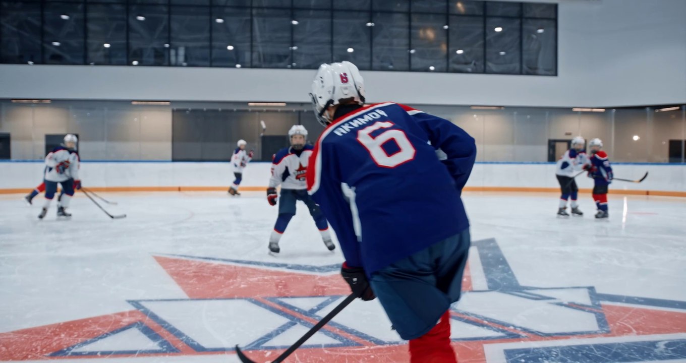 People Playing Hockey at an Ice Rink