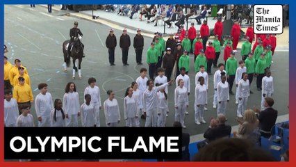 Olympic flame presented during Bastille Day parade in Paris