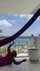 Woman Topples Over While Trying to Sit in Hammock With Glass of Mimosa