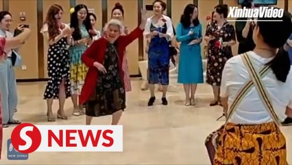 Dancing grandma steals the show at theater flash mob