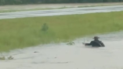 Person swims across median of flooded Illinois highway as heavy rain causes road closures
