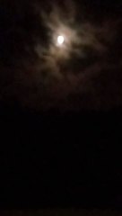 the moon passing behind the clouds