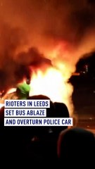 Police car flipped over and bus on fire in Leeds as riots break out