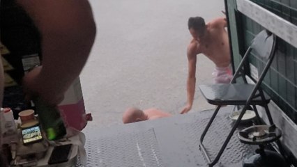 Intense storm turns comical as man falls out of trailer trying to help friend