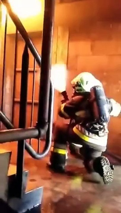 Firefighters using water as a shield