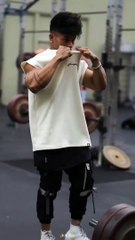 "Gym boy does a hard workout in the gym."