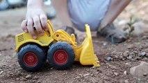 Little boy plays with toy earth mover