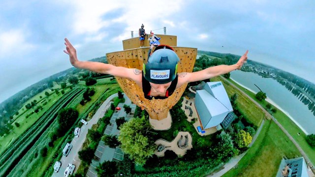 Duo scale world's tallest freestanding climbing wall - before base jumping off