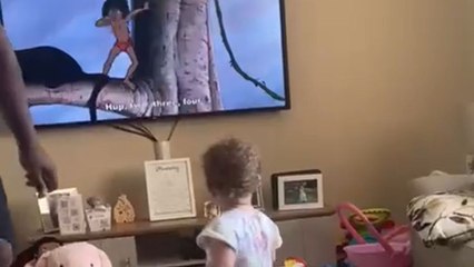 Adorable toddler marching along to The Elephant Song makes dad join in too