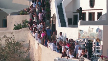 Greece's Santorini bursts with tourists as locals seek cap