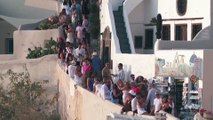 Greece's Santorini bursts with tourists as locals seek cap