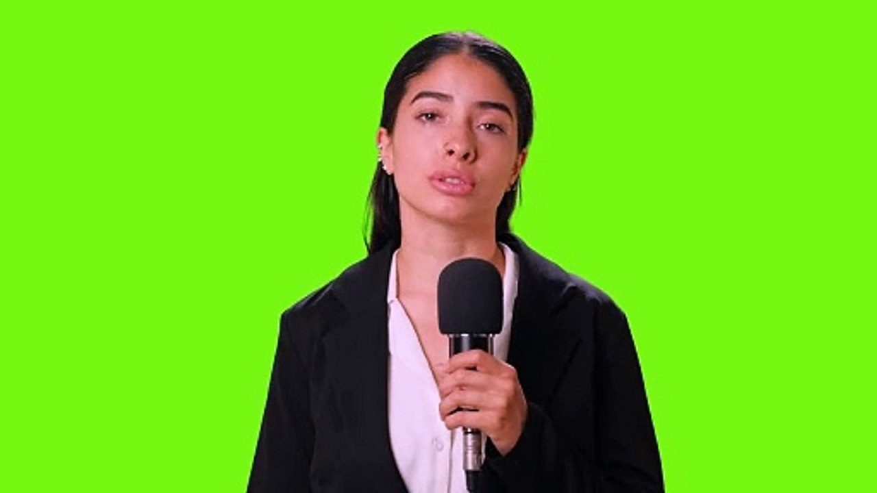 Female reporter reporting with microphone in hand on a chroma green background