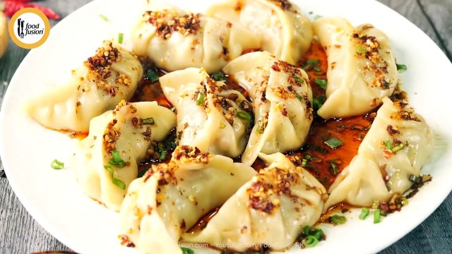 Chicken dumplings with a kick of chilli oil and dumpling sauce.