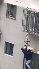 Neighbours rescue boy dangling from 4th-floor window in China